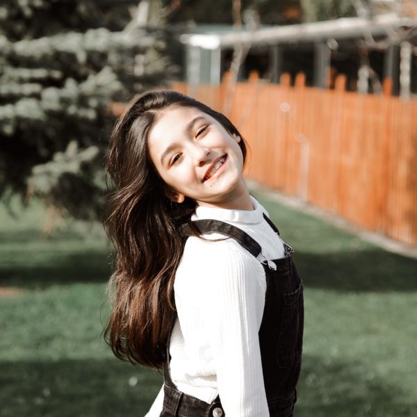 Smiling girl around 11 years old outdoors